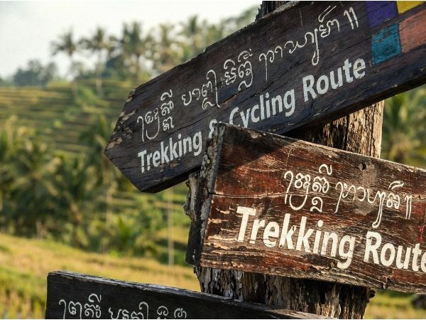 Handpainted signs in Tabanan identify trekking and cycling routes.