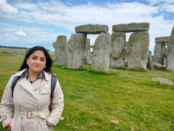 Sneha Banerjee standing in front of the Stonehenge monument in the United Kingdom