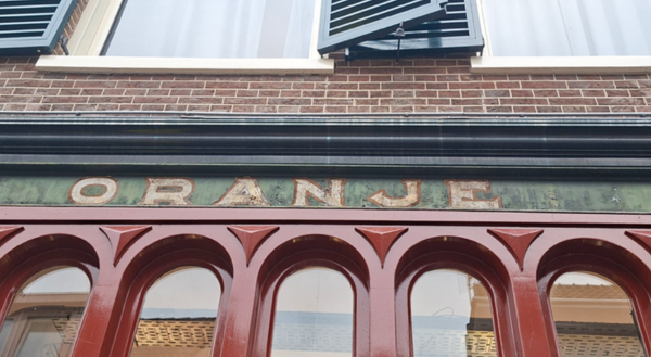 Antique signage featuring the name "Oranje."