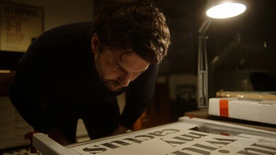Foundry Stories - Rene Still A still image from Foundry Stories showing Rene Bieder in his studio looking at type.