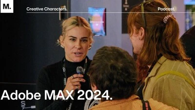 Designer Meg Lewis interviewing an attendee at Adobe MAX 2024.