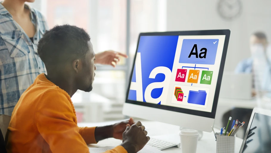 Professional creative working at a screen examining font choices.